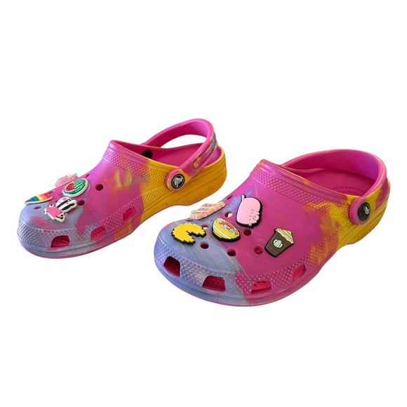 Colorful children's clogs with cartoon character decorations on a white background