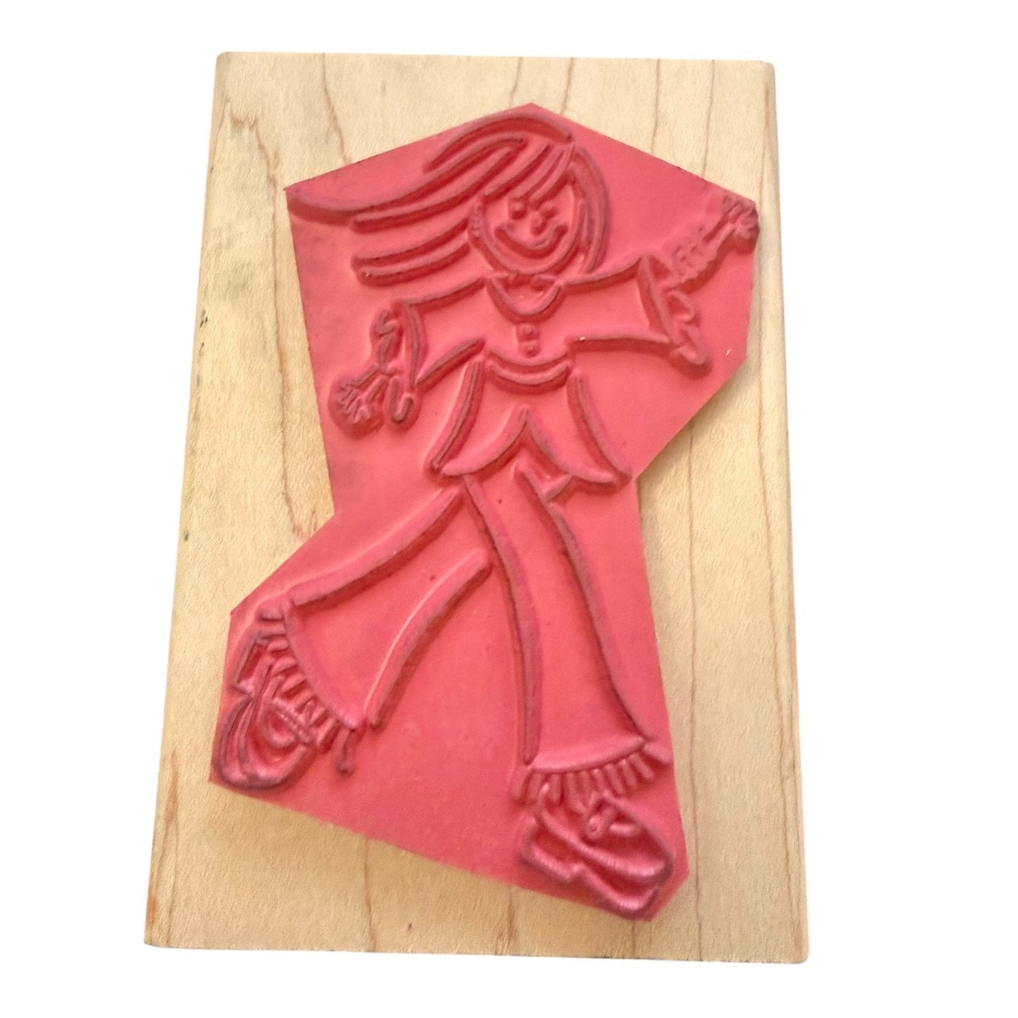 Red rubber stamp of a person on a wooden block
