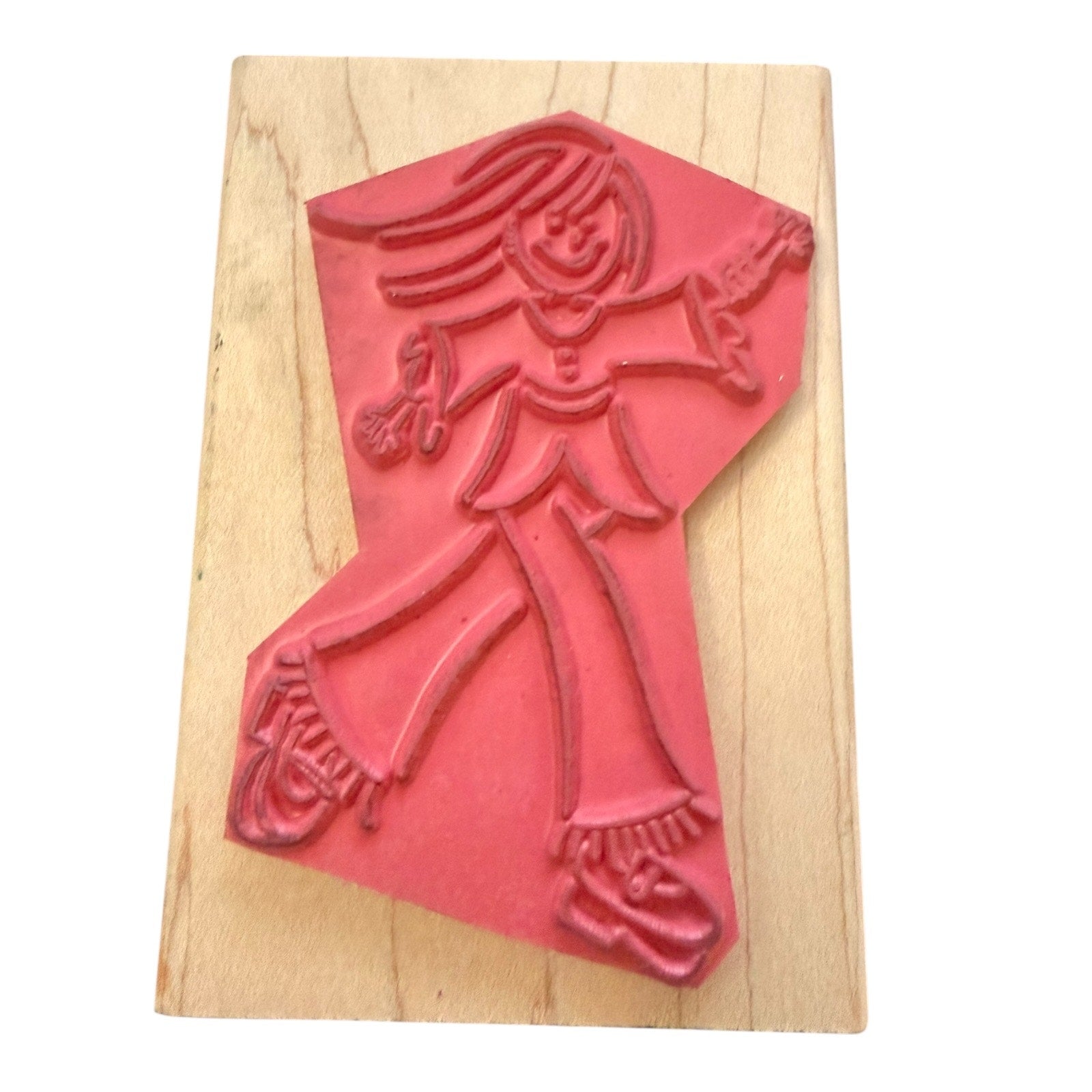Red rubber stamp of a person on a wooden block
