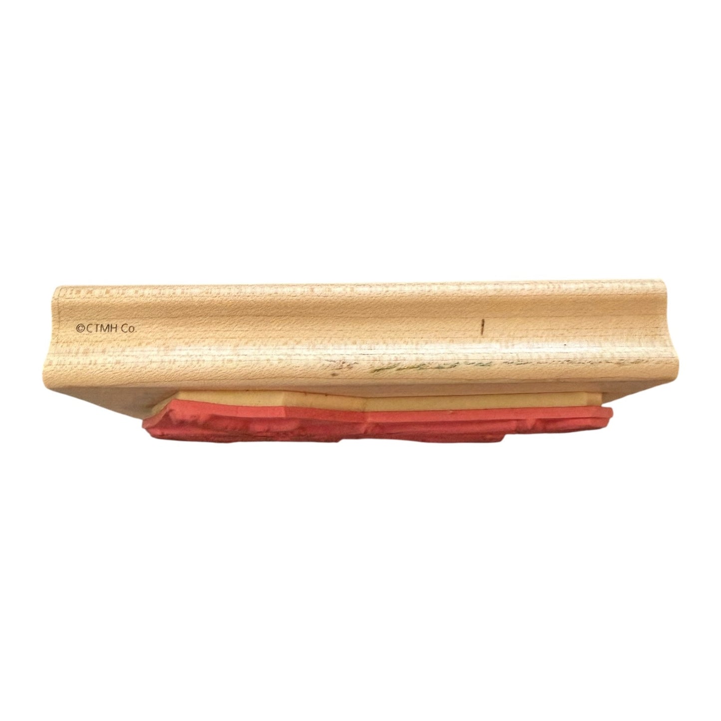 Wooden block with red stamp on a white background