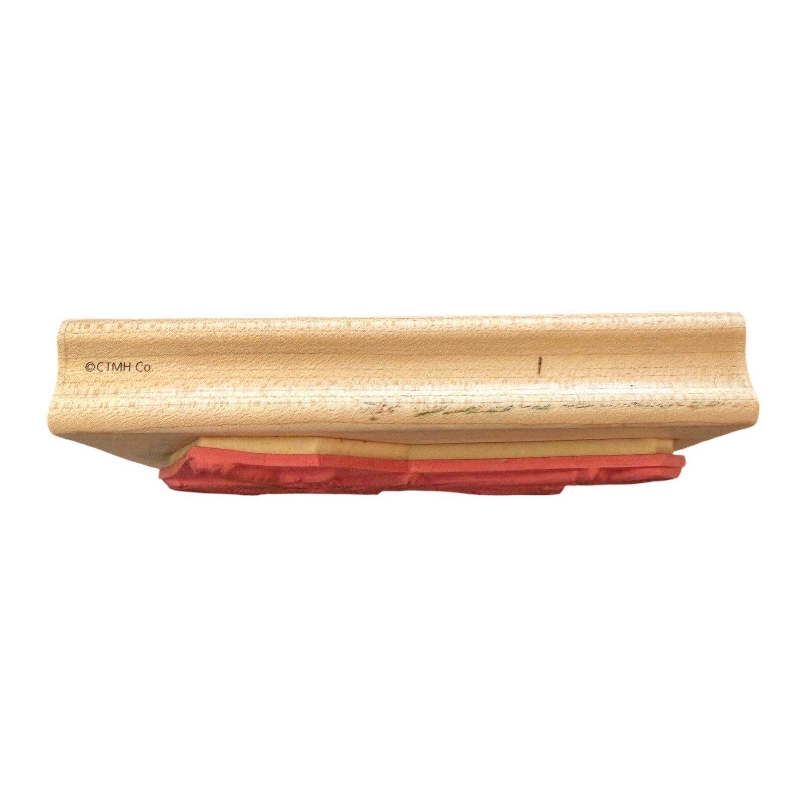 Wooden block with red stamp on a white background