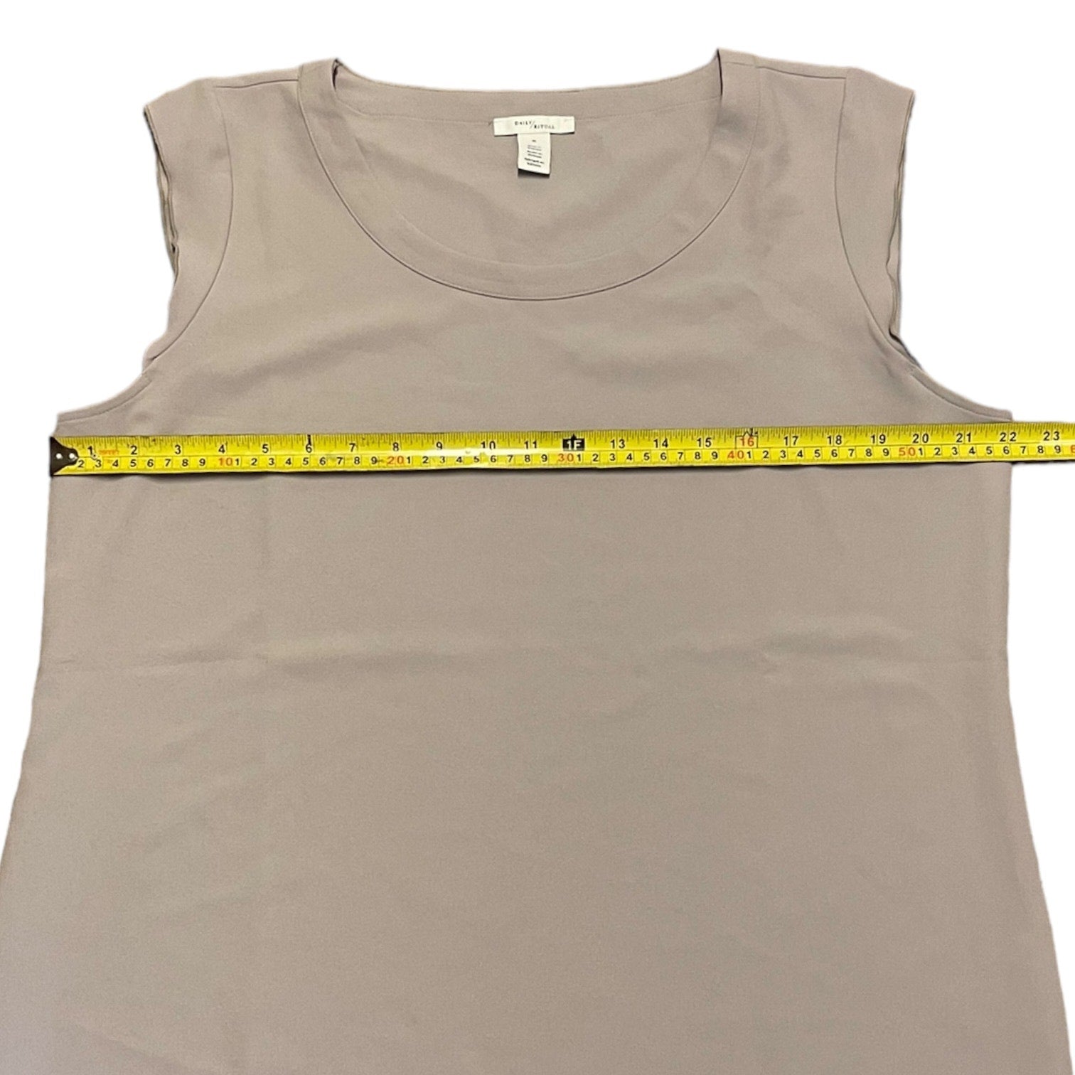 Gray tank top with a measuring tape on a white background