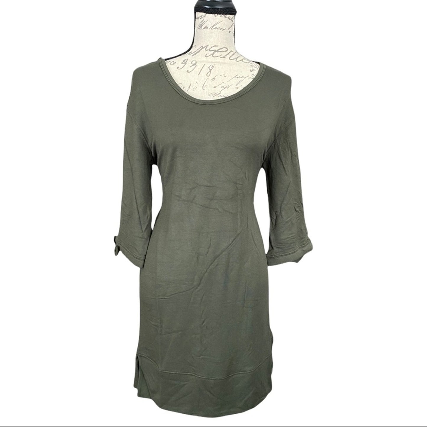 An olive green long-sleeve tunic dress displayed on a vintage-style mannequin torso against a plain white background.