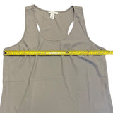 Gray tank top with a measuring tape laid across it on a white background
