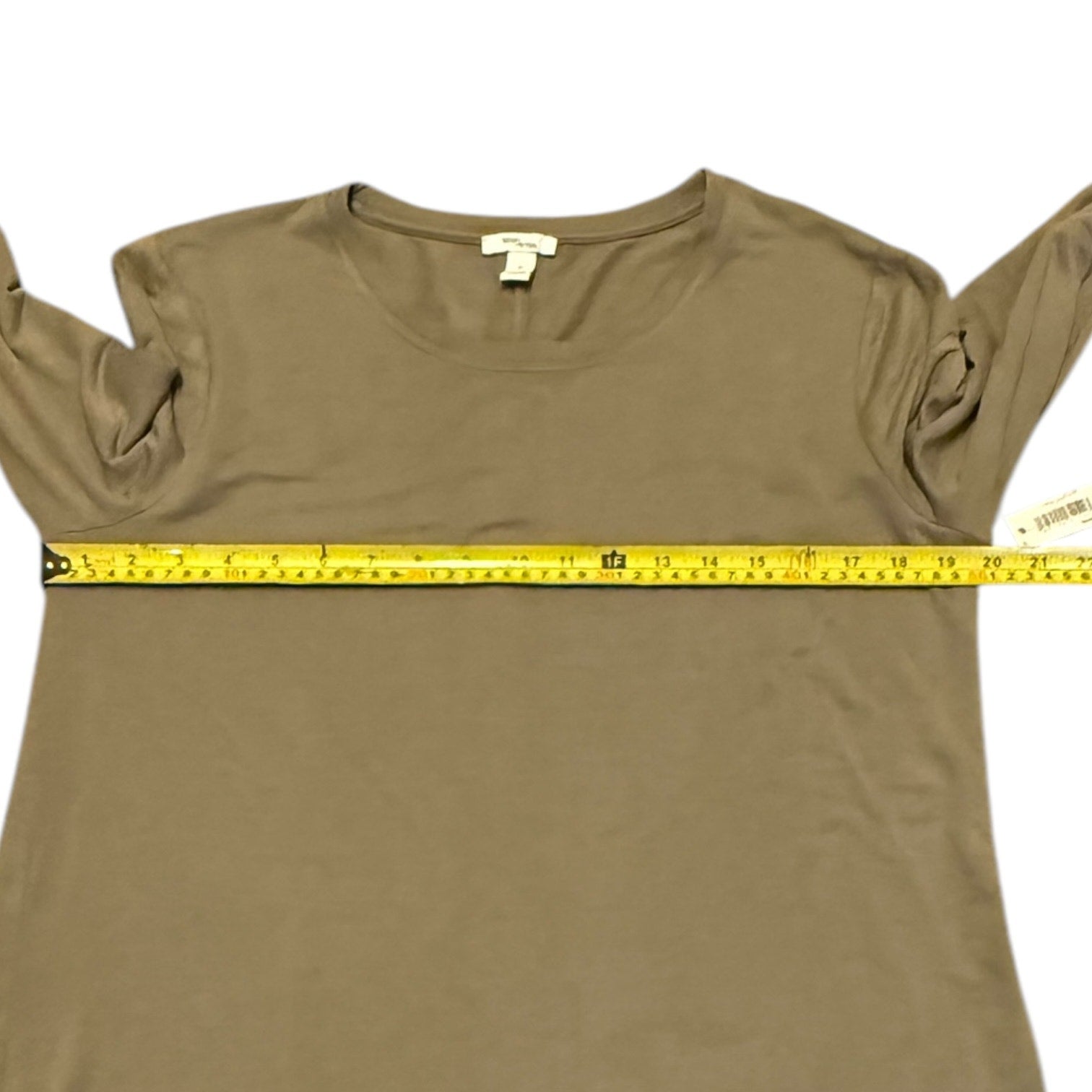 Mocha shirt with measuring tape across it on a white background