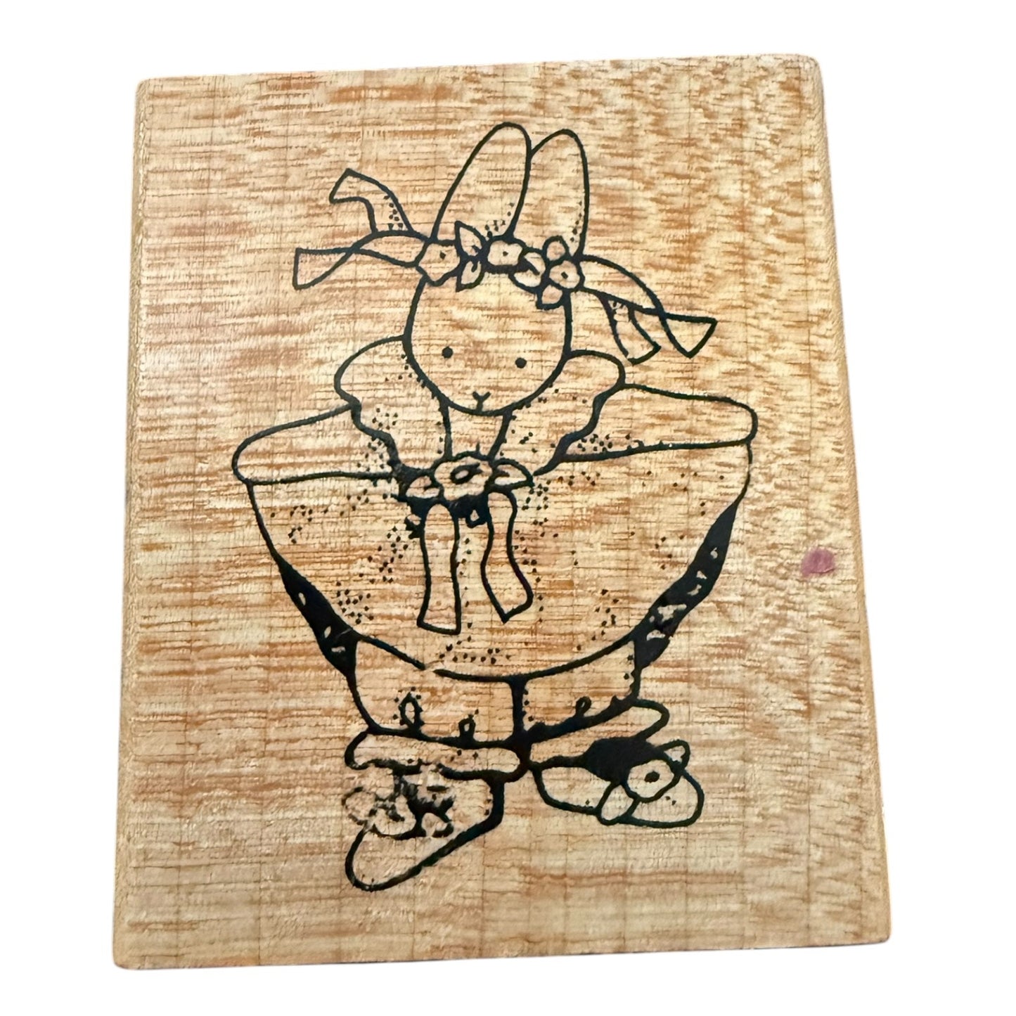 Wood block stamp with a girl bunny in a dress on a white background