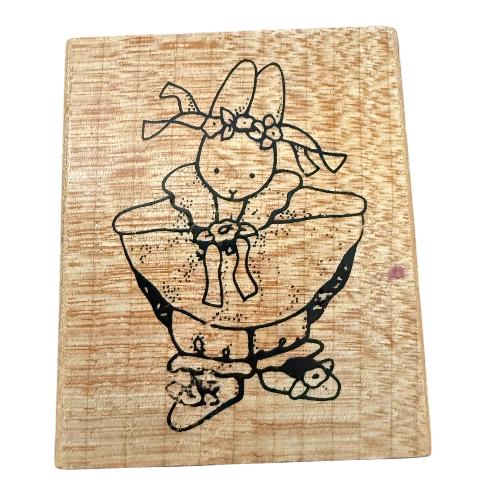 Wood block stamp with a girl bunny in a dress on a white background