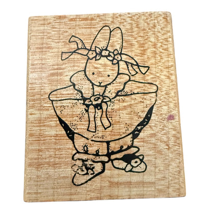 Wood block stamp with a girl bunny in a dress on a white background