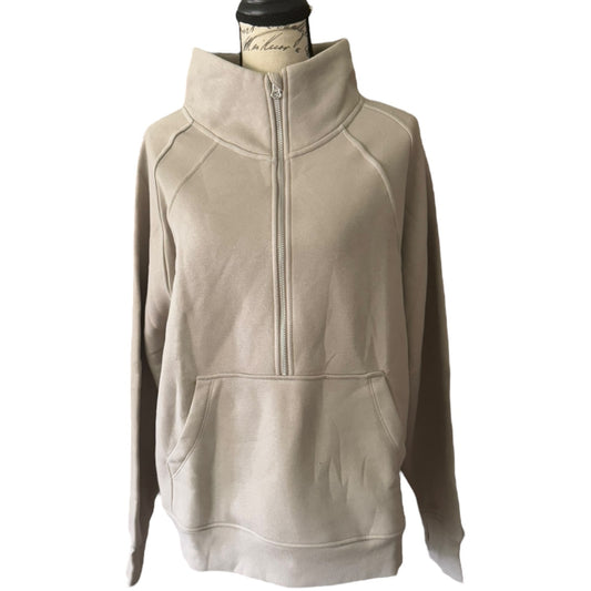 Front of beige pullover on a mannequin against a white background