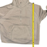 Beige sweatshirt with a measuring tape displayed on a white background