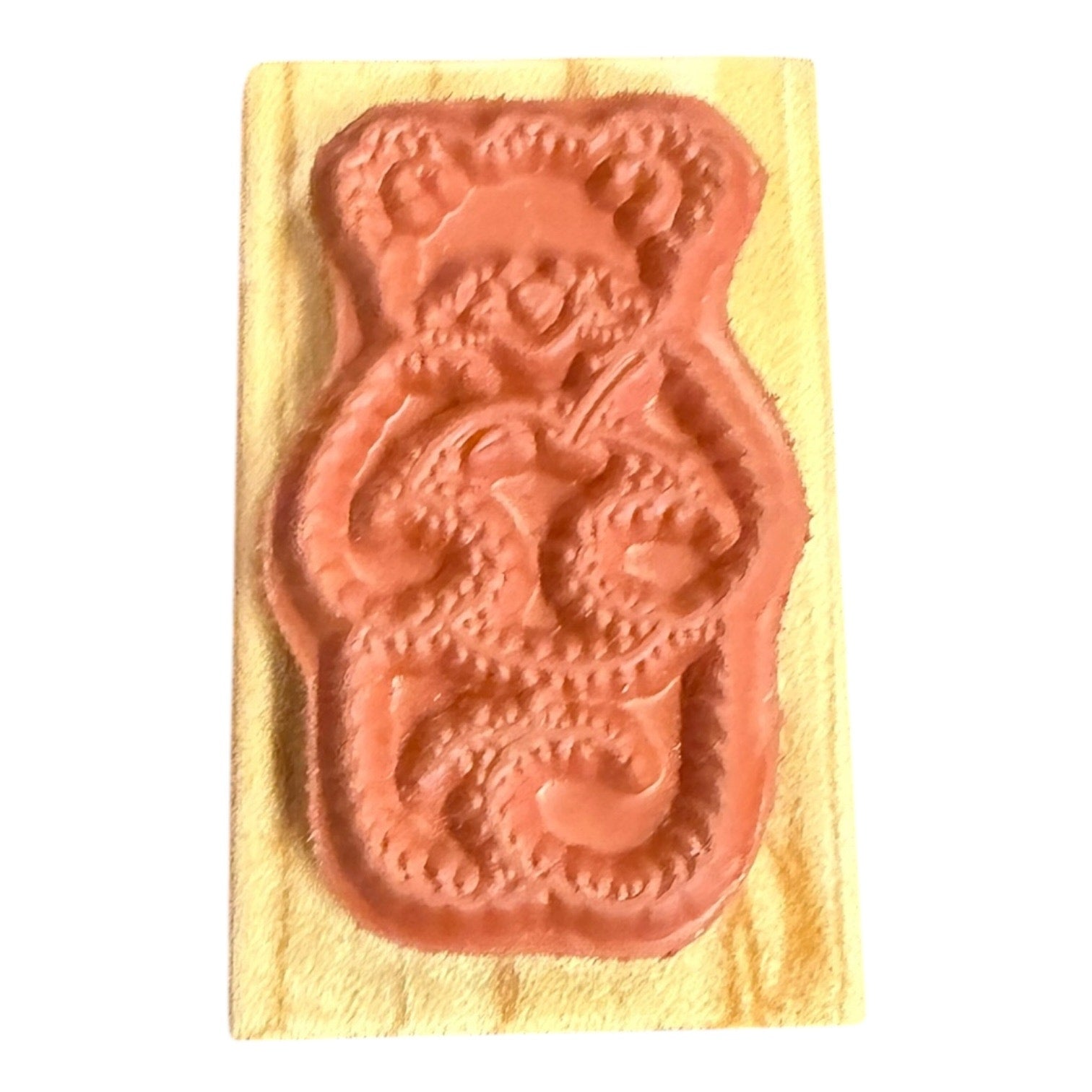 Decorative wooden stamp with bear design on a white background