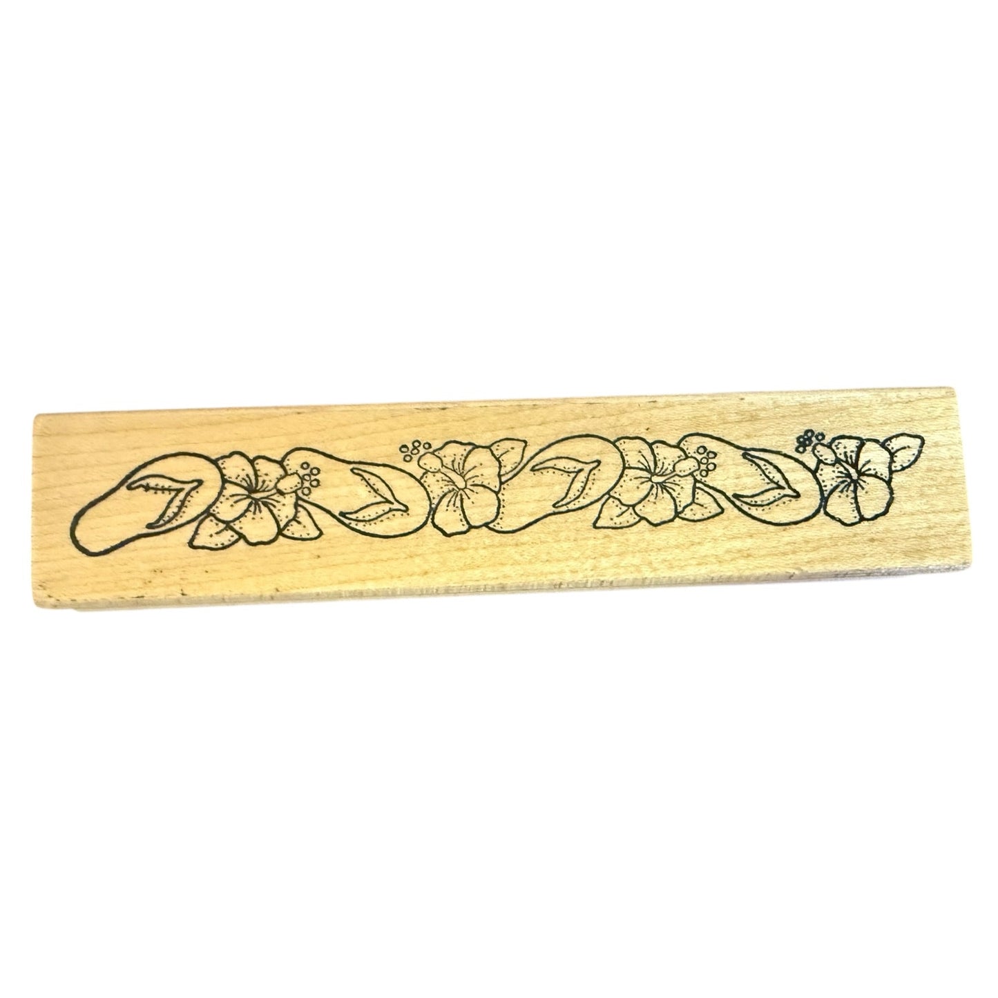 Wooden stamp with floral design on a white background