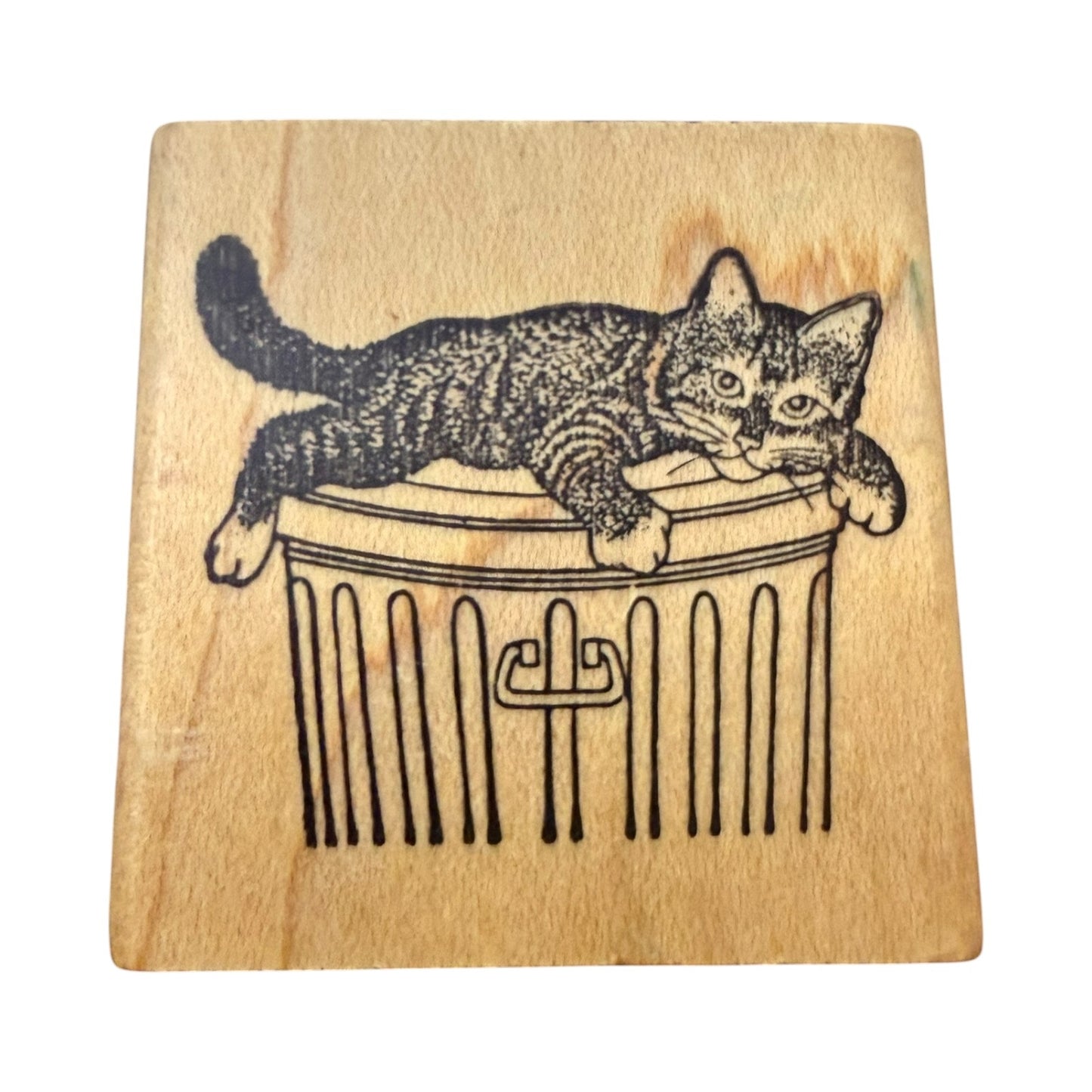 Cat on a trash can rubber stamp on a white back ground