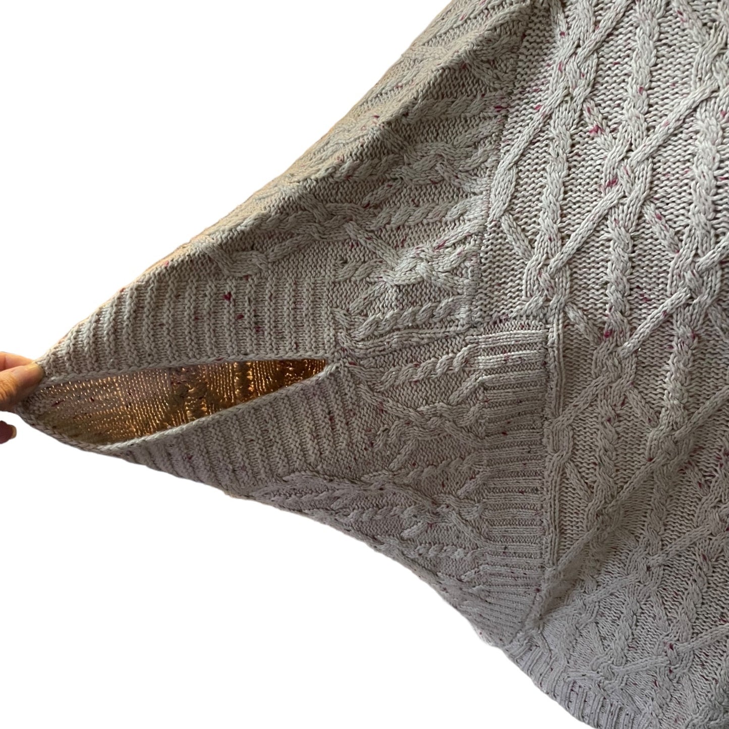 Sleeve of pink knitted sweater on a white back ground