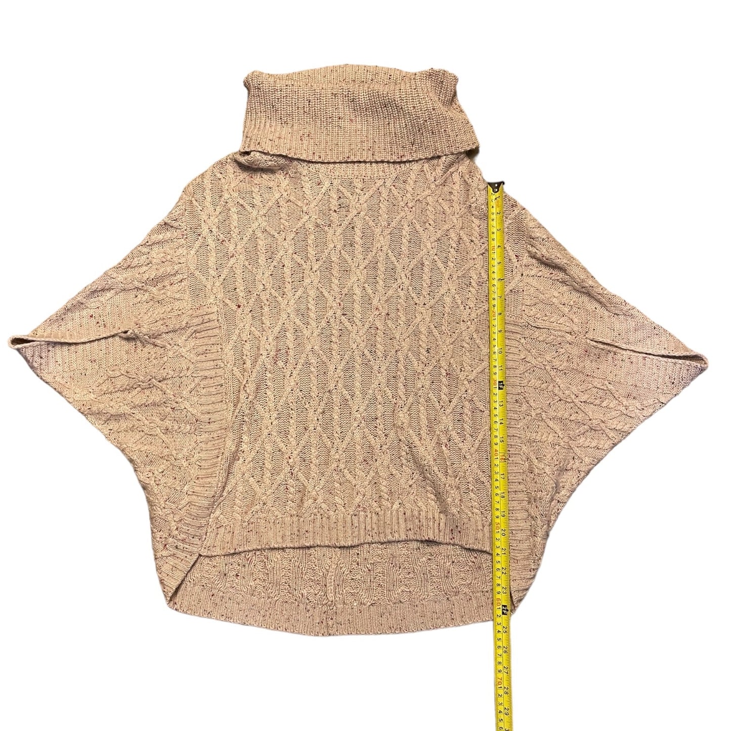 Sweater with a measuring tape for size reference on a white background