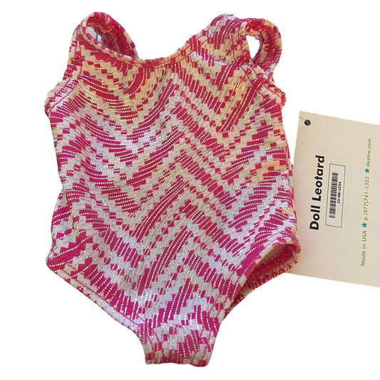 Pink and white patterned doll leotard with a label on a white background