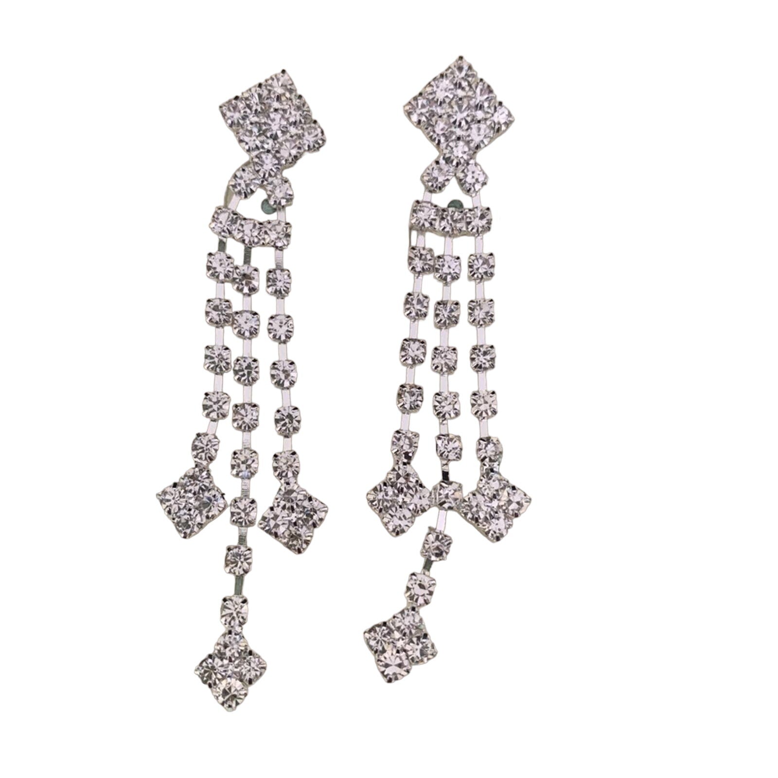 A pair of silver-toned dangle earrings embellished with clear rhinestones in a geometric, multi-tiered design, shown against a plain white background.