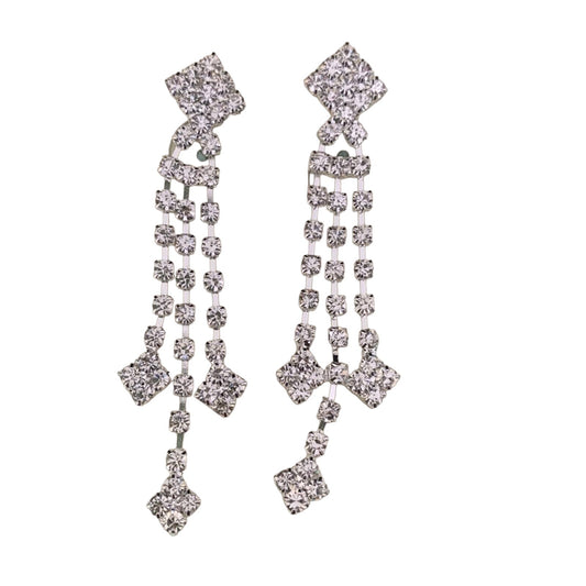 A pair of silver-toned dangle earrings embellished with clear rhinestones in a geometric, multi-tiered design, shown against a plain white background.