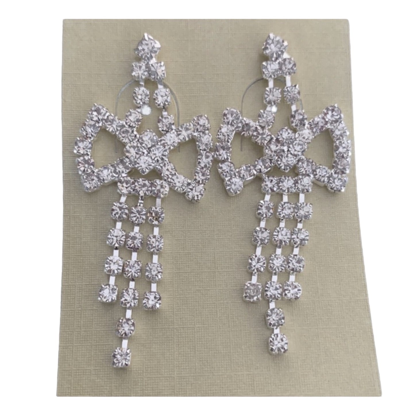 Pair of silver chandelier earrings on a beige card