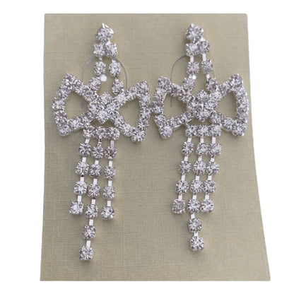 Pair of silver chandelier earrings on a beige card