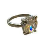 Silver ring with a large CZ gemstone on a white background