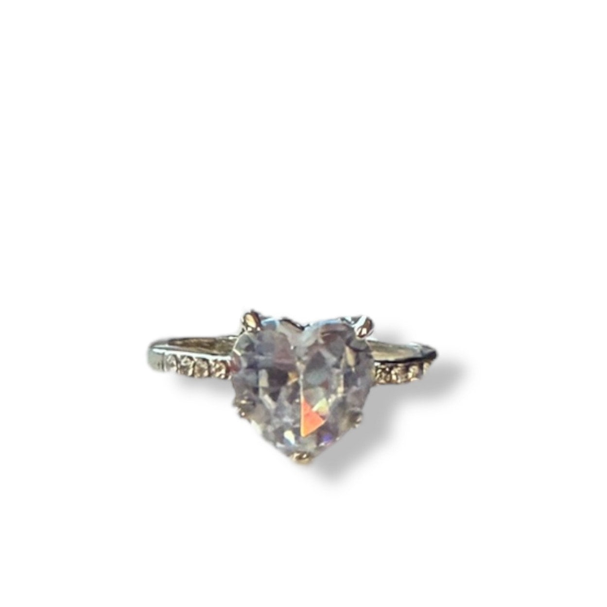 A heart-shaped iridescent gemstone ring set in a silver-toned band with small accent stones on either side, shown against a plain white background.