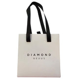 White tote box with black handles and 'Diamond Nexus' text on a white background
