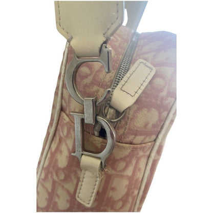 Close-up of a patterned handbag with a prominent metal clasp on a white background