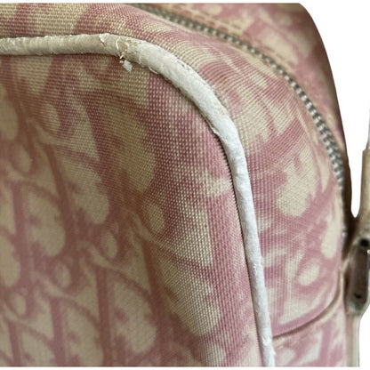 Close-up of a pink and white patterned bag with a visible brand logo and issues