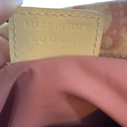 Close-up of a label on pink fabric with 'Made in Italy' text.