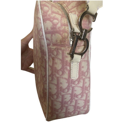 Side of Pink and white patterned handbag with a visible brand logo on a white background