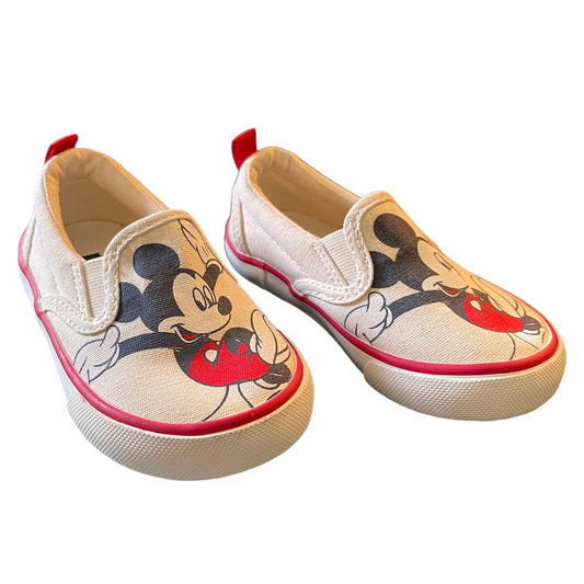Front side of Pair of children's shoes with Mickey Mouse design on a white background