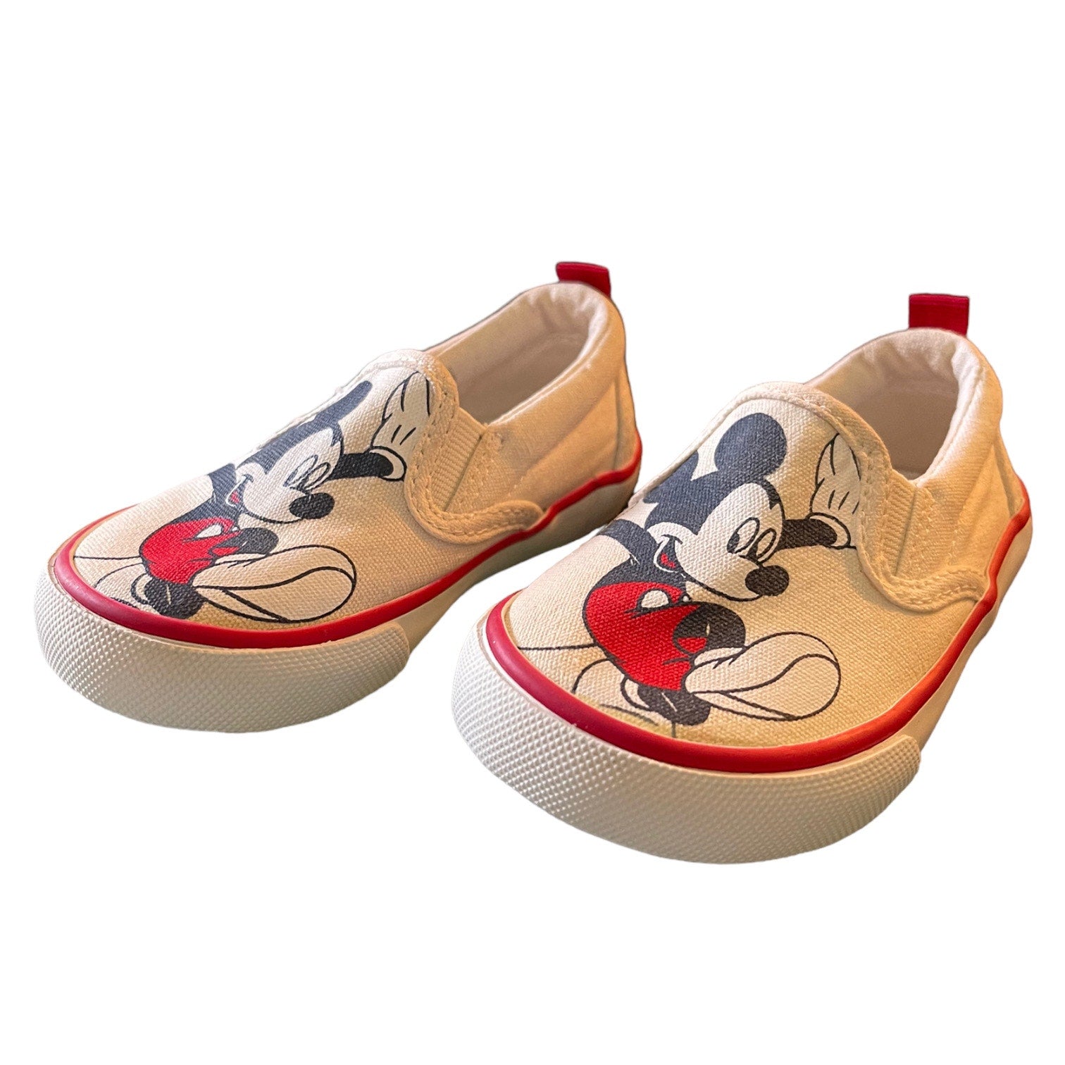 Front side of Pair of children's shoes with cartoon character design on a white background