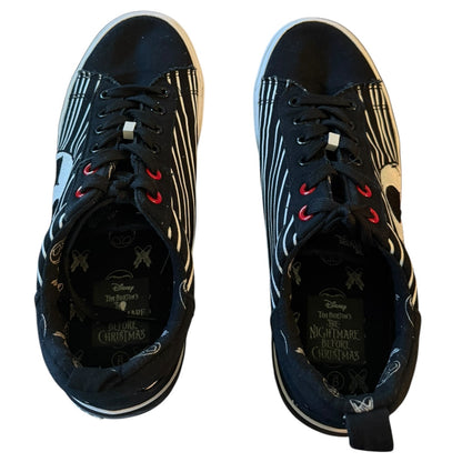 Pair of black sneakers with decorative patterns on a white background