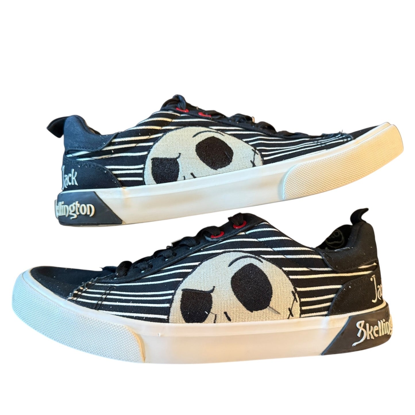 Pair of sneakers with a jack skellington design on a white background