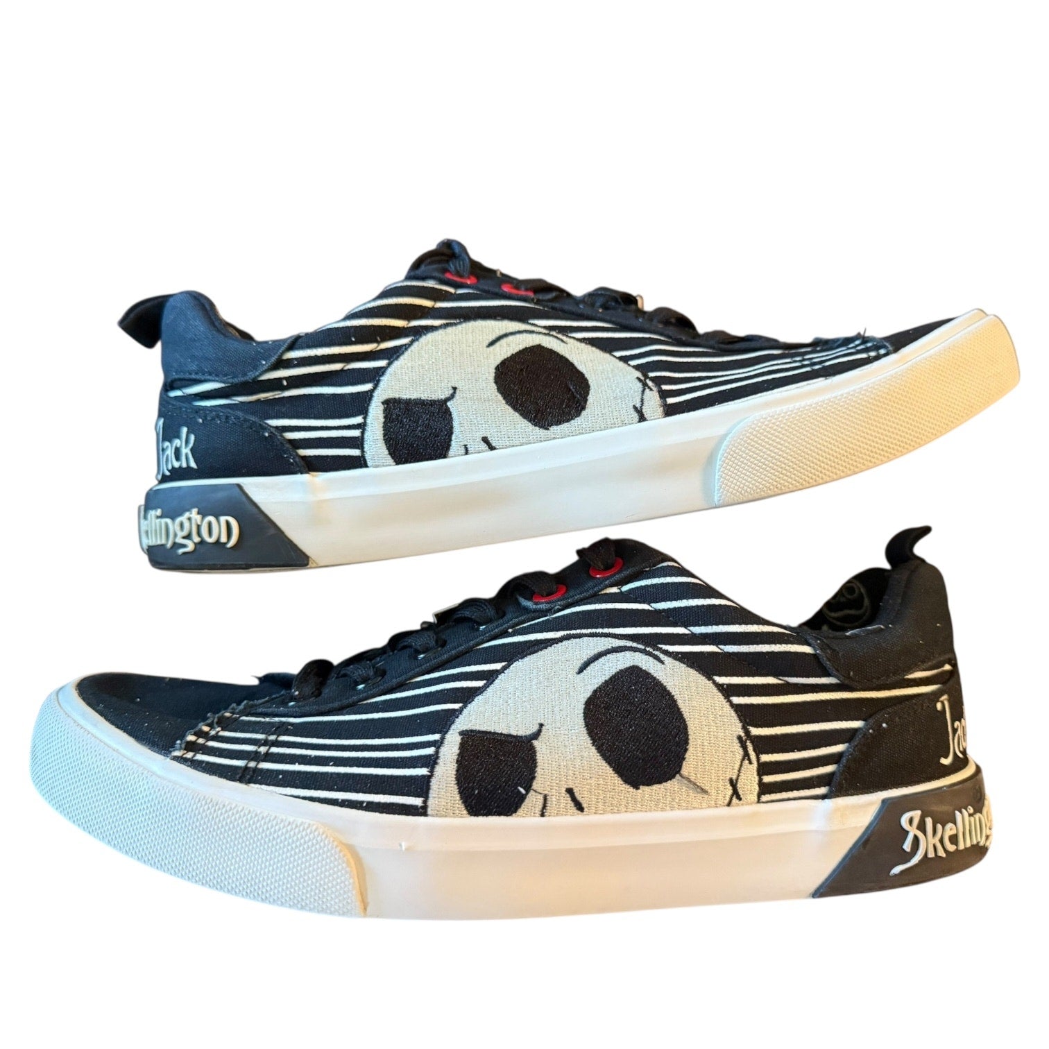 Pair of sneakers with a jack skellington design on a white background