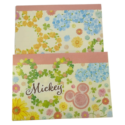 Floral patterned stationery with 'Mickey' text and logo on a white background