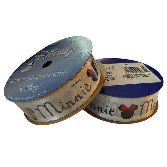 Disney Minnie Mouse ribbon spools on a white background, featuring a white ribbon printed with 'Minnie' Mouse head silhouettes.