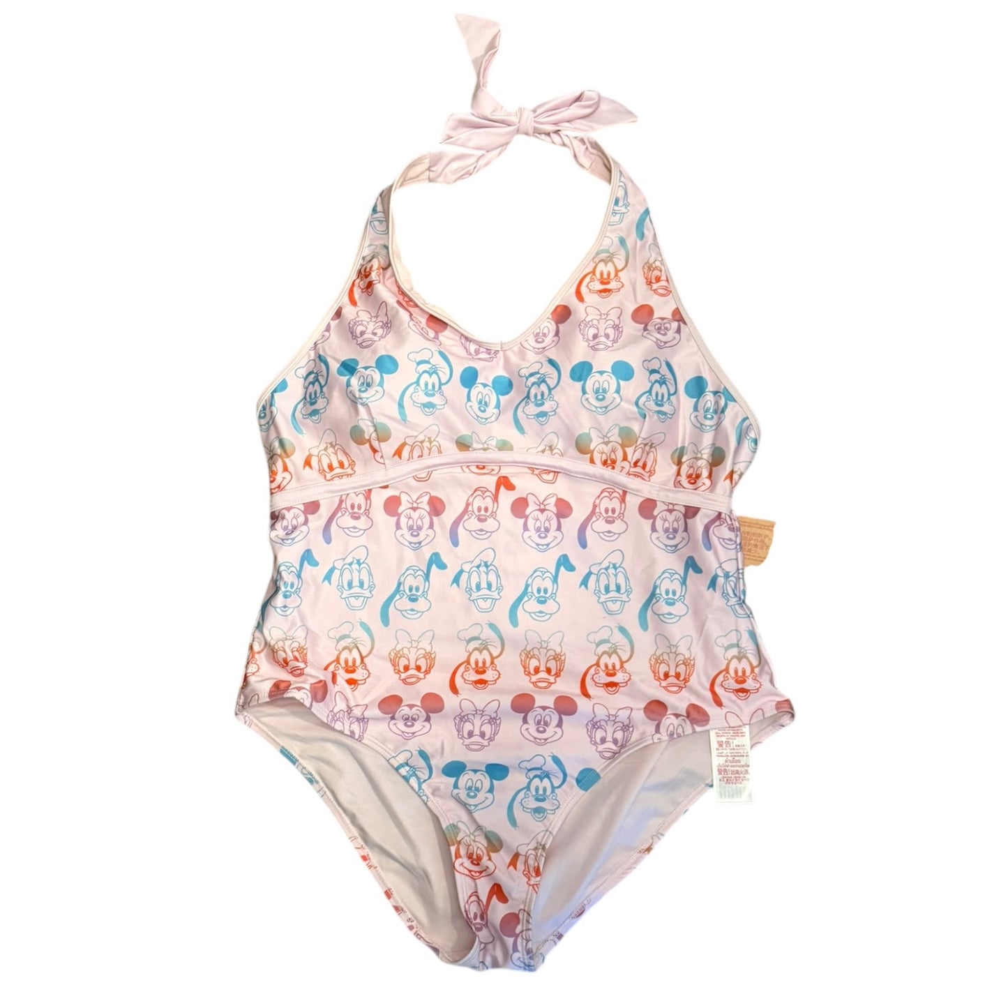 A women's one-piece halter swimsuit featuring an all-over repeating print of Disney characters' faces, including Mickey Mouse, Minnie Mouse, Donald Duck, Daisy Duck, and Pluto, on a light pink background. The swimsuit has a tie-strap halter neckline and a small tan tag on the right side.