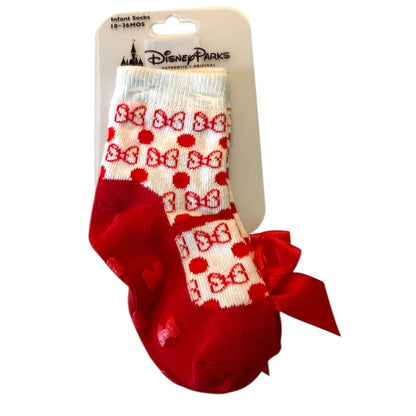 Red and white baby socks with bow design on a Disney Parks packaging