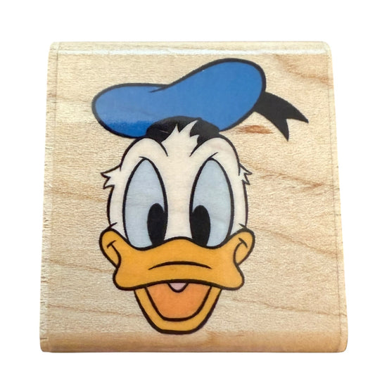 Wooden block with a Donald Duck featuring a blue hat on a white background