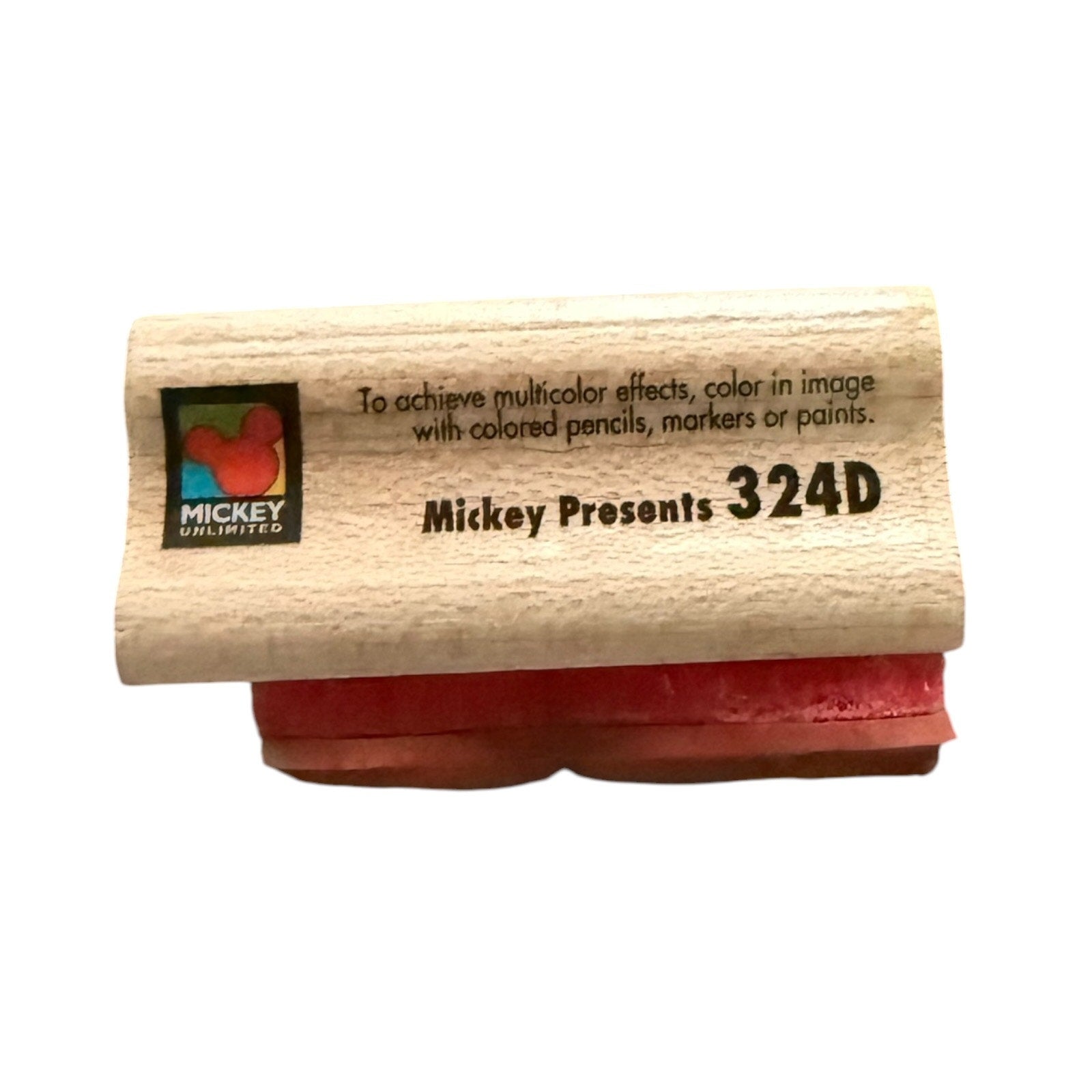 Wooden stamp with red pad and 'Mickey Unlimited' branding on a white background