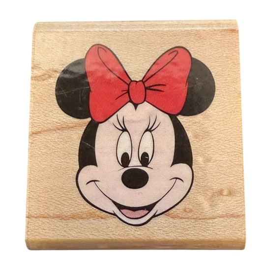 Wooden block with a Minnie Mouse face featuring a red bow on a white background
