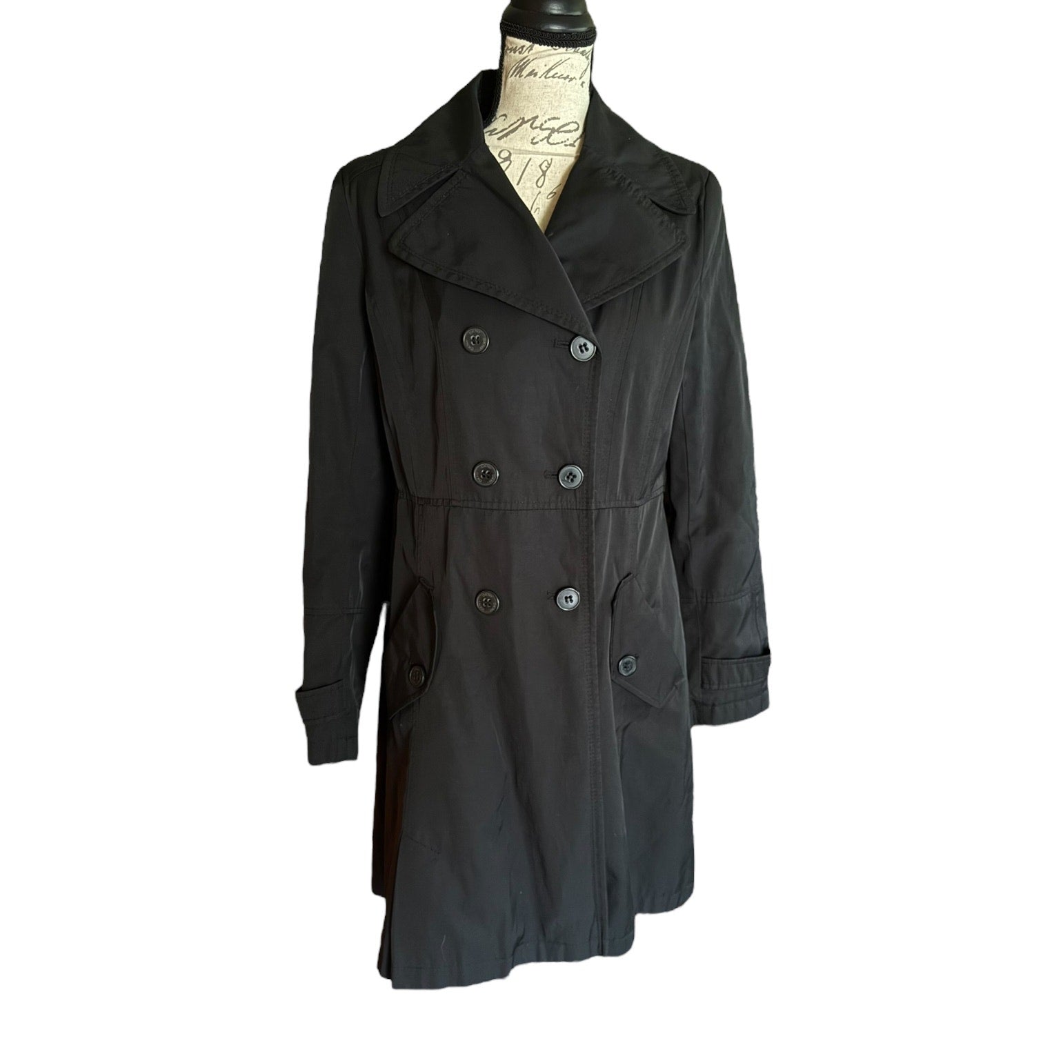 Front of Black trench coat on a mannequin against a white background
