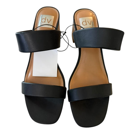 Black sandals with a visible brand label on a white background