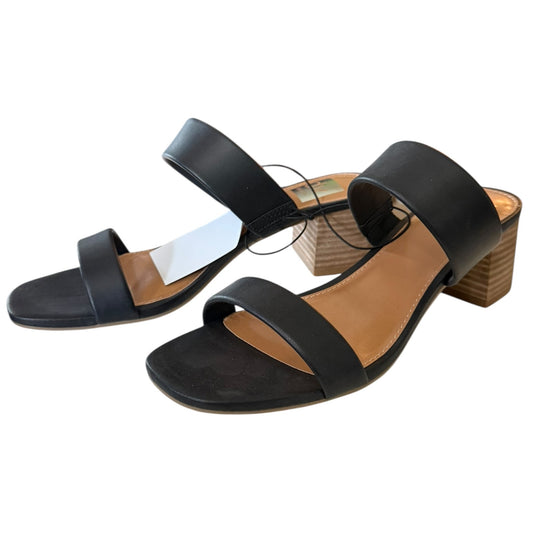 Black sandals with a faux wooden heel on a white background
