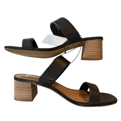Side of Black sandals with wooden block heels on a white background