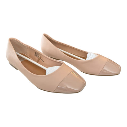 Pair of blush flat shoes on a white background
