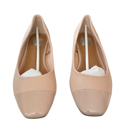 Pair of blush ballet flat shoes on a white background