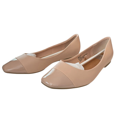Pair of blush flat shoes on a white background